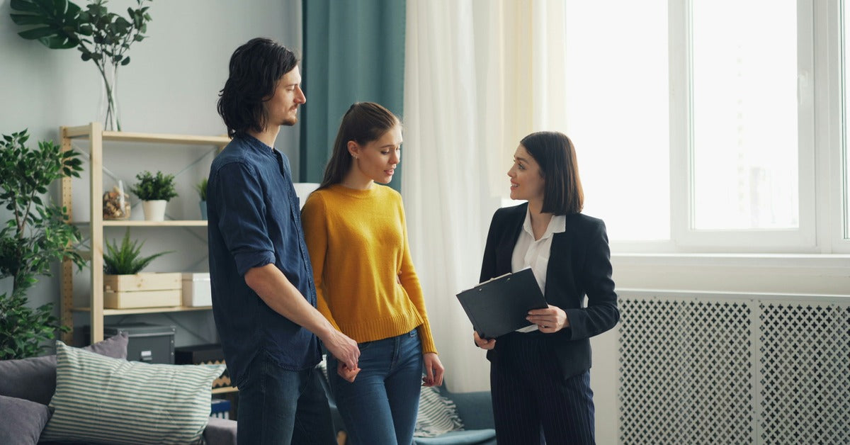 Real estate agent showing clients a home