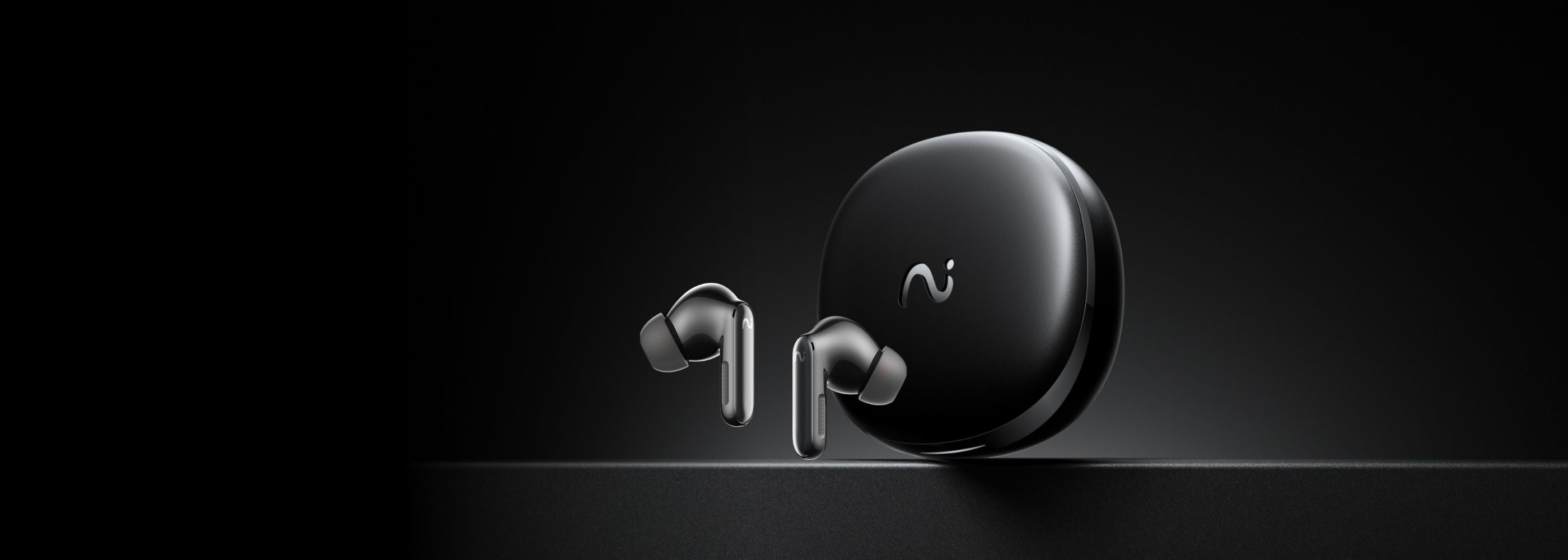 Black wireless earbuds with charging case on a black background